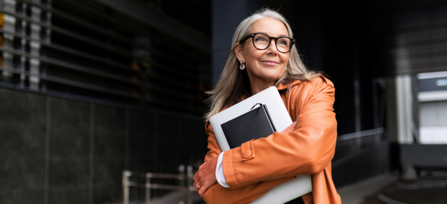 Woman smiling while carrying notebook