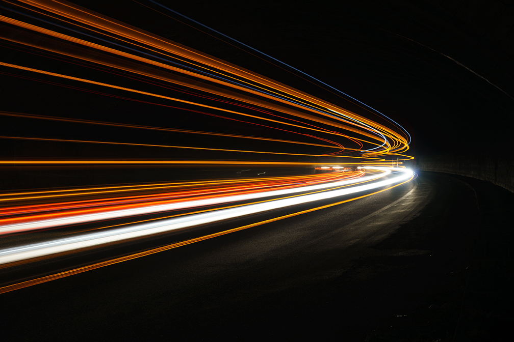 Abstract orange and blue lights on a road.