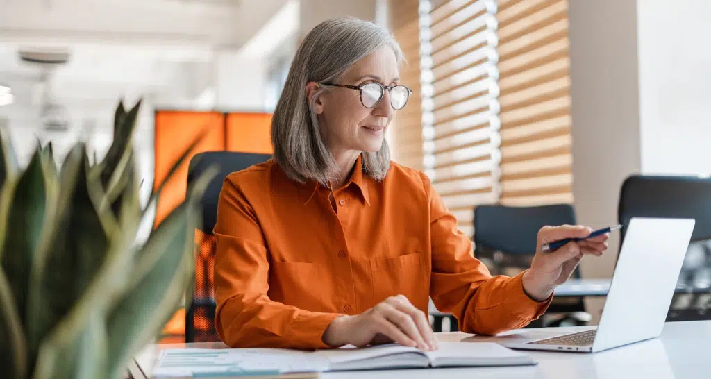 Woman in orange at laptop