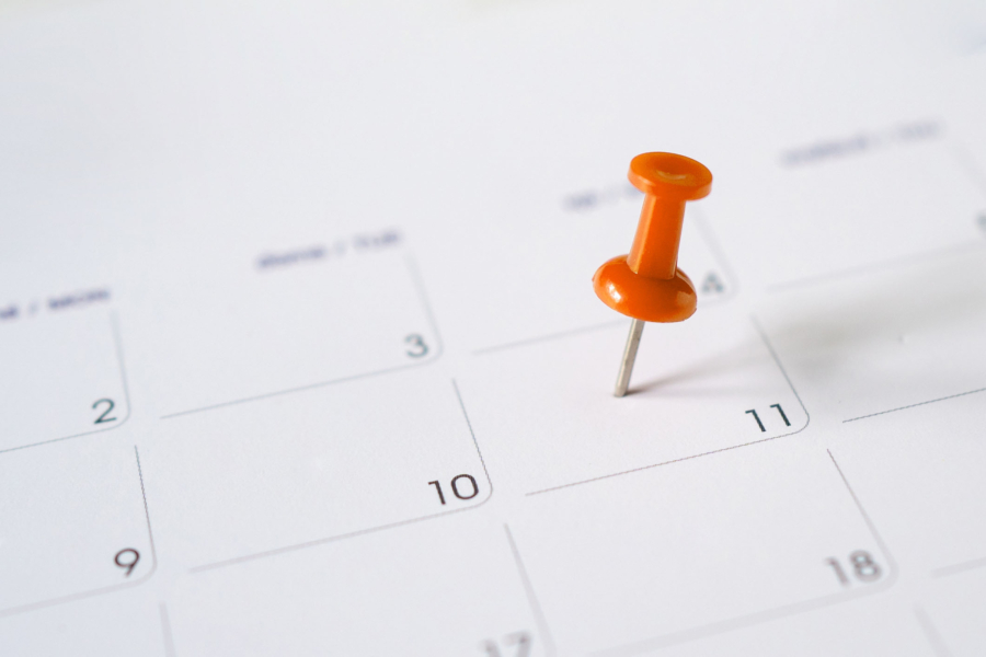 A calendar with a pin to signify an impending timeline.