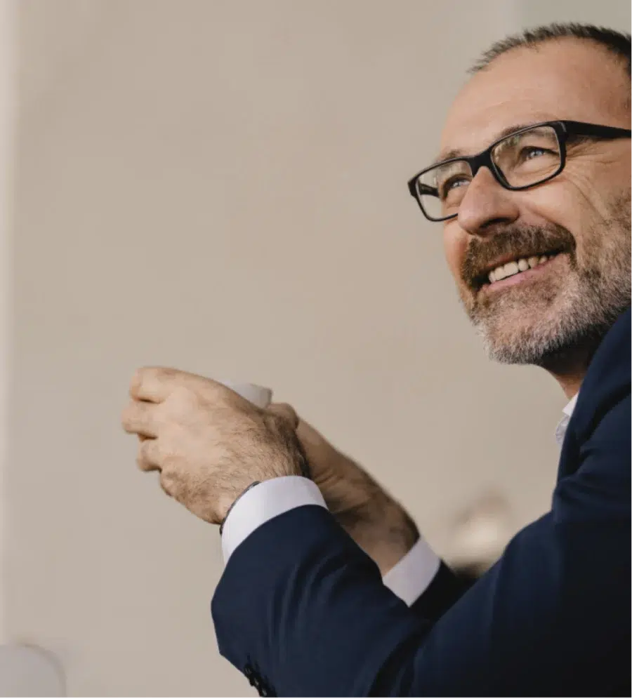 Business man holding coffee in his hand and listening to others