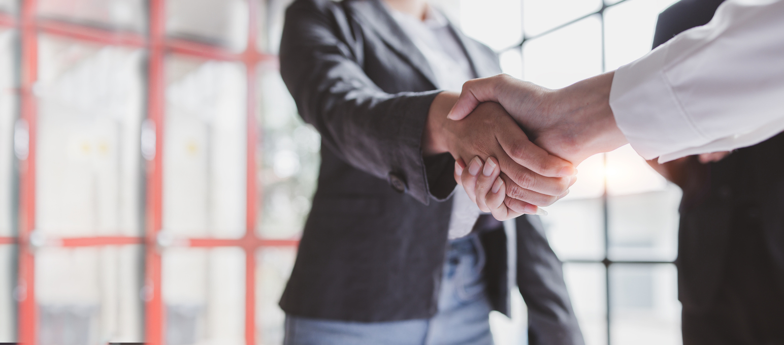 Business handshake for teamwork of business merger and acquisition,successful negotiate,hand shake,two businessman shake hand with partner to celebration partnership and business deal concept