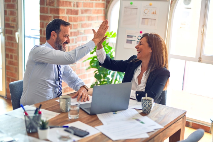a man and a woman are giving each other a high five