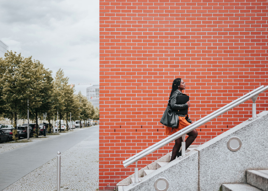Woman walking up a flight up stairs, similar to the steps when finding contract review software