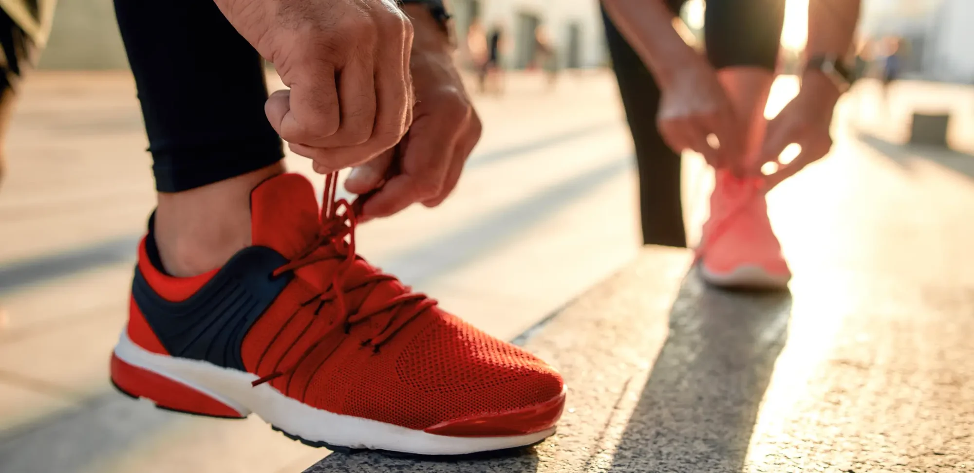 Two people tying shoelaces.